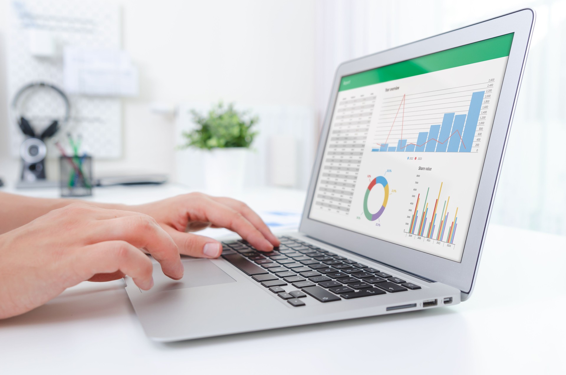 Man working with spreadsheet on laptop