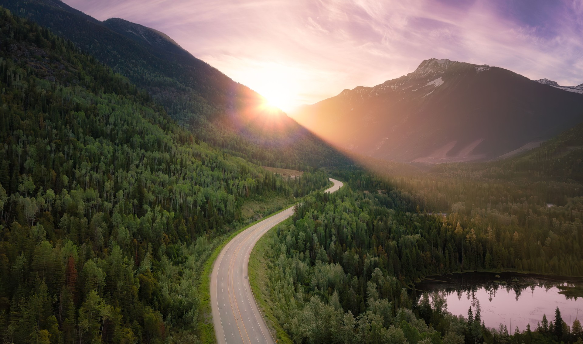 Scenic road in the valley surrounded by the Canadian Mountains. Aerial. Scenic road in the valley surrounded by the Canadian Mountains. Aerial.
